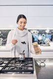 Woman scooping Prana Chai out of packet